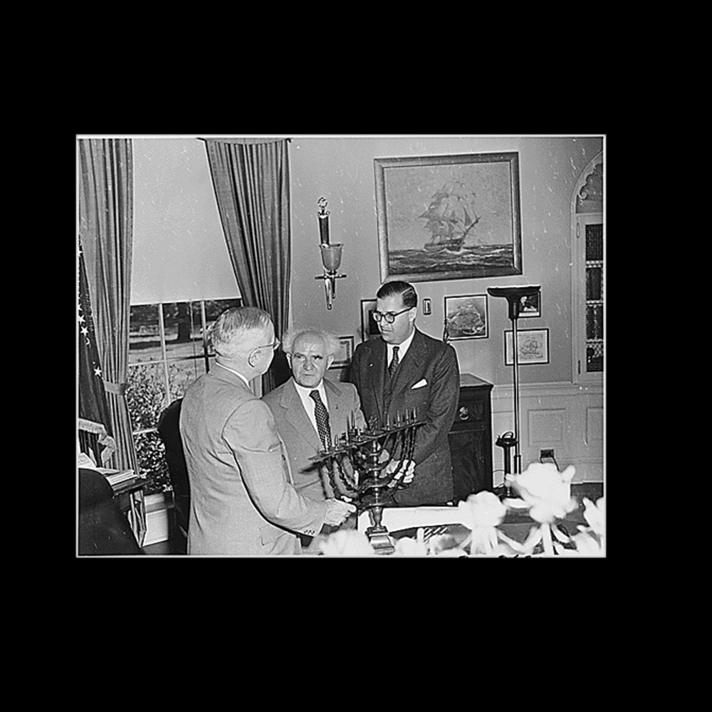 President Truman in the Oval Office, evidently receiving a Menorah as a gift from the Prime Minister of Israel, David Ben-Gurion.