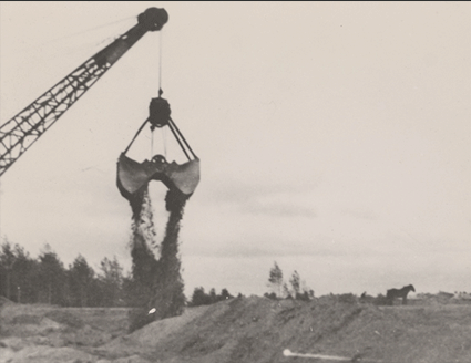 Black & white image of heavy construction equipment excavating the Treblinka site